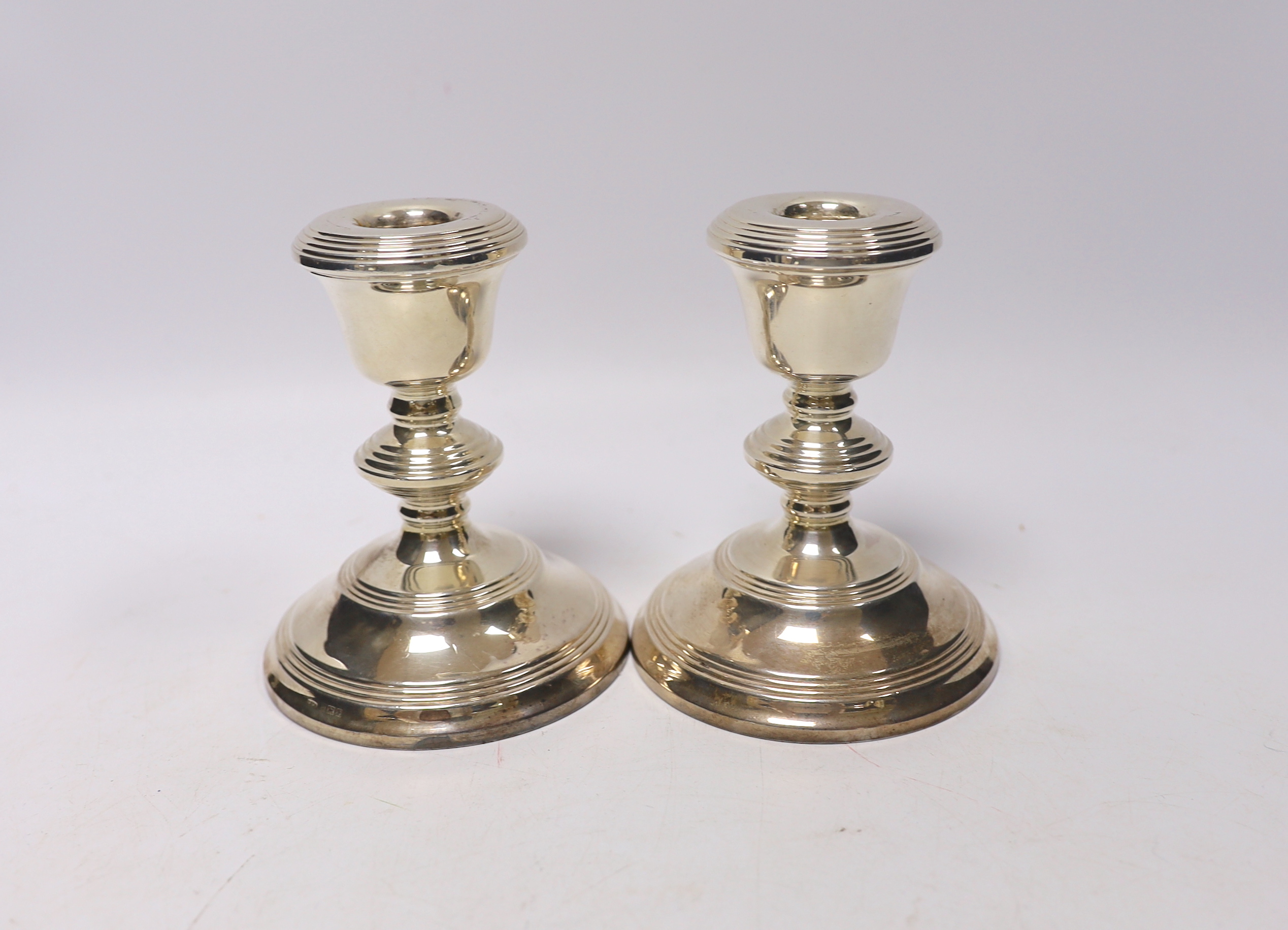 A George V silver christening mug by Charles Edwards, London, 1912, 86mm, together with two silver mounted cigarette boxes, two silver cigarette cases, a pair of silver mounted dwarf candlesticks, a silver vesta case, a